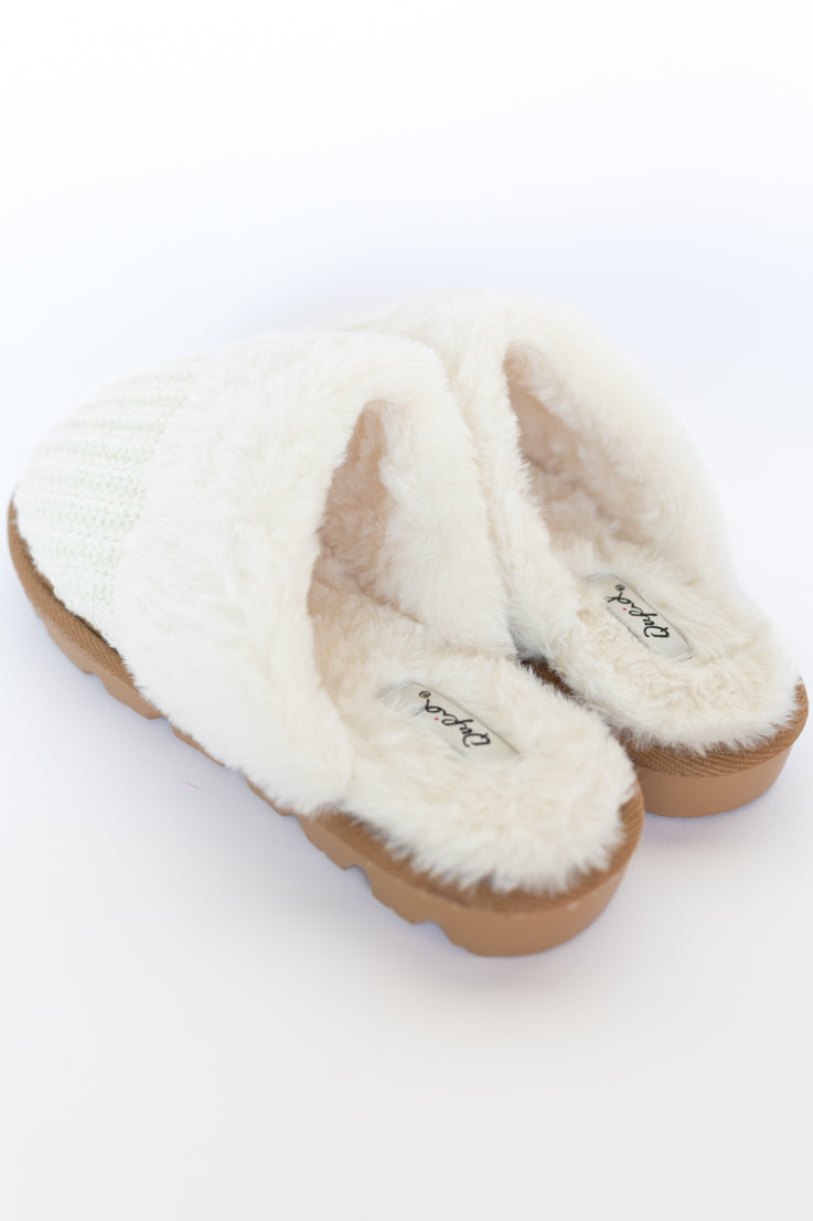 beige fuzzy slippers