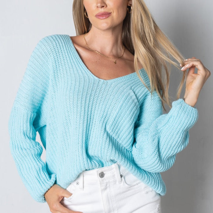 blue ribbed relaxed fit sweater with pocket on front