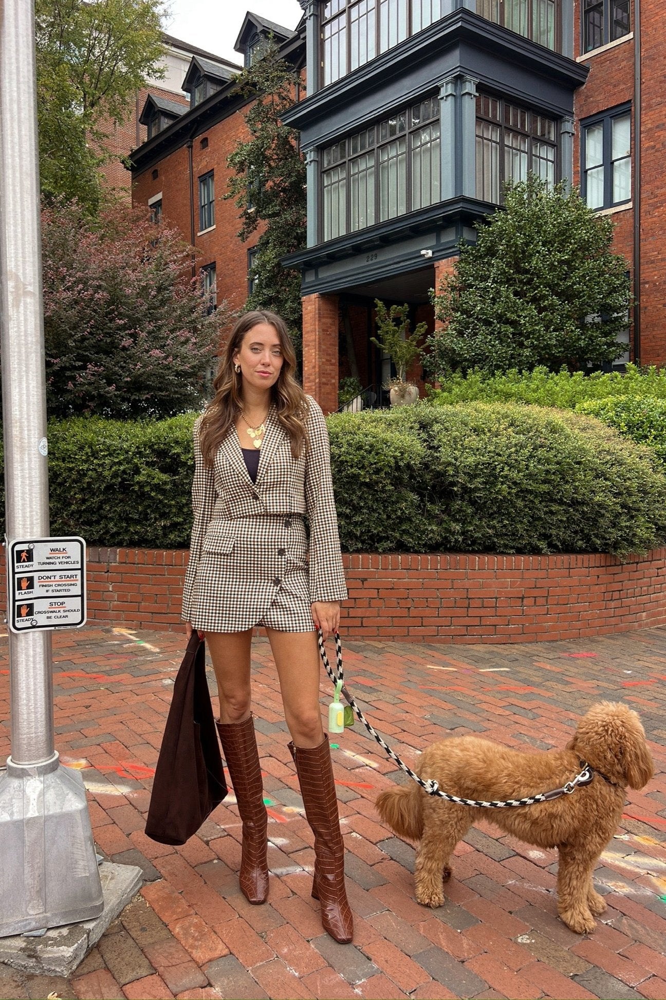 brown plaid set outfit with asymmetrical brown button detail mini skirt and a cropped structured matching blazer