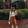 chestnut brown leather micro shorts and cream mock neck cropped sweater outfit front