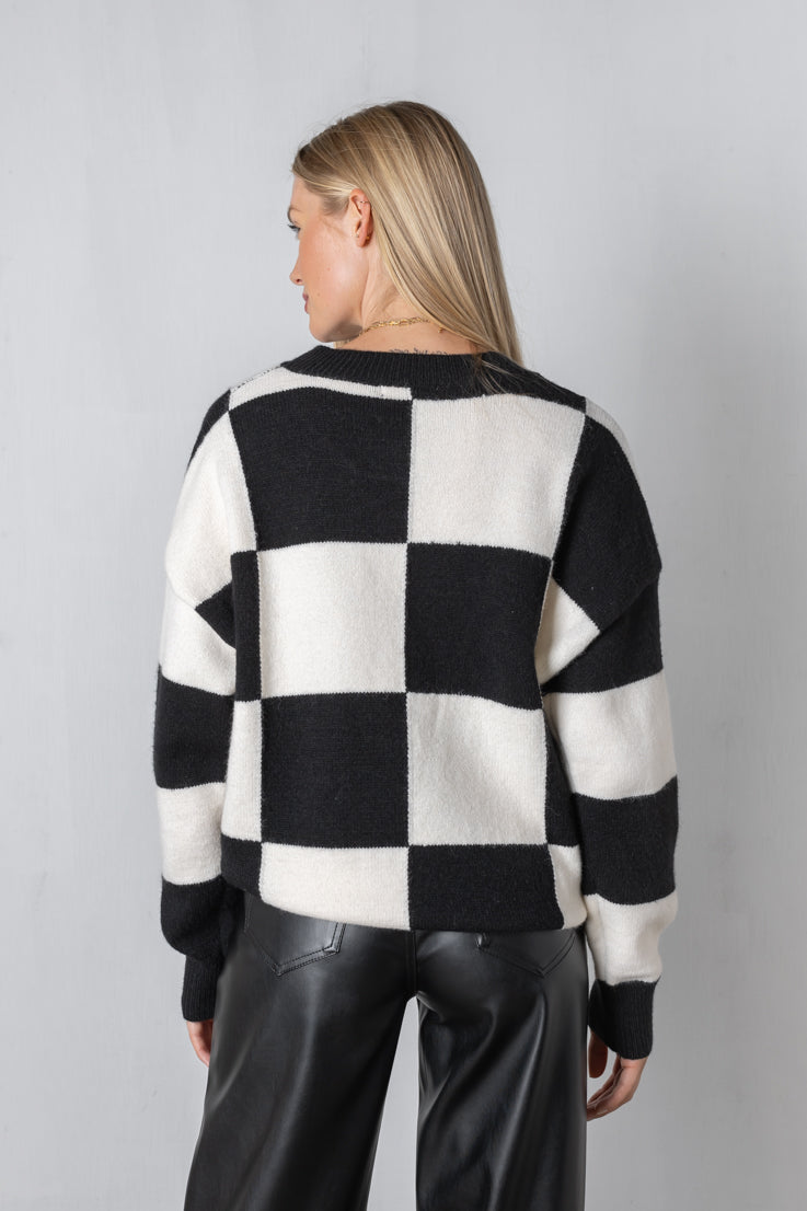 black checkerboard pattern sweater