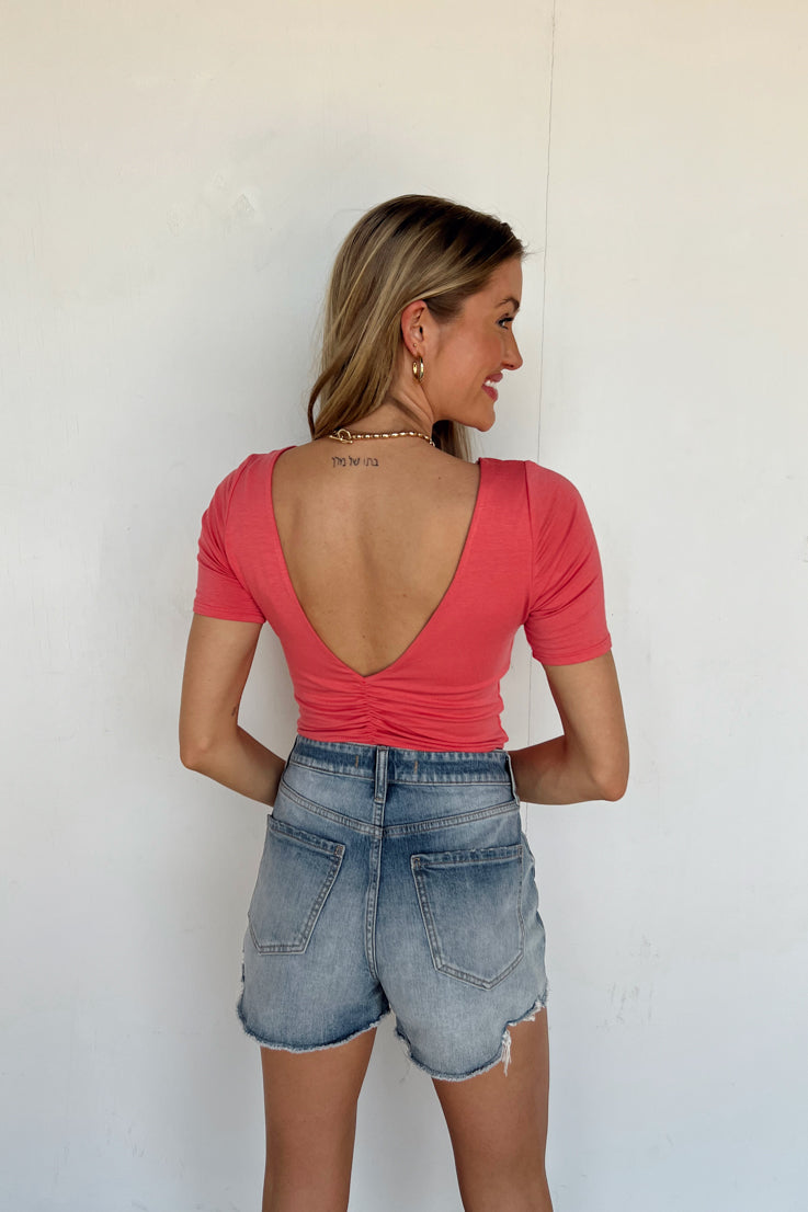 pink crew neck bodysuit with open back