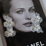 white floral dangly earrings