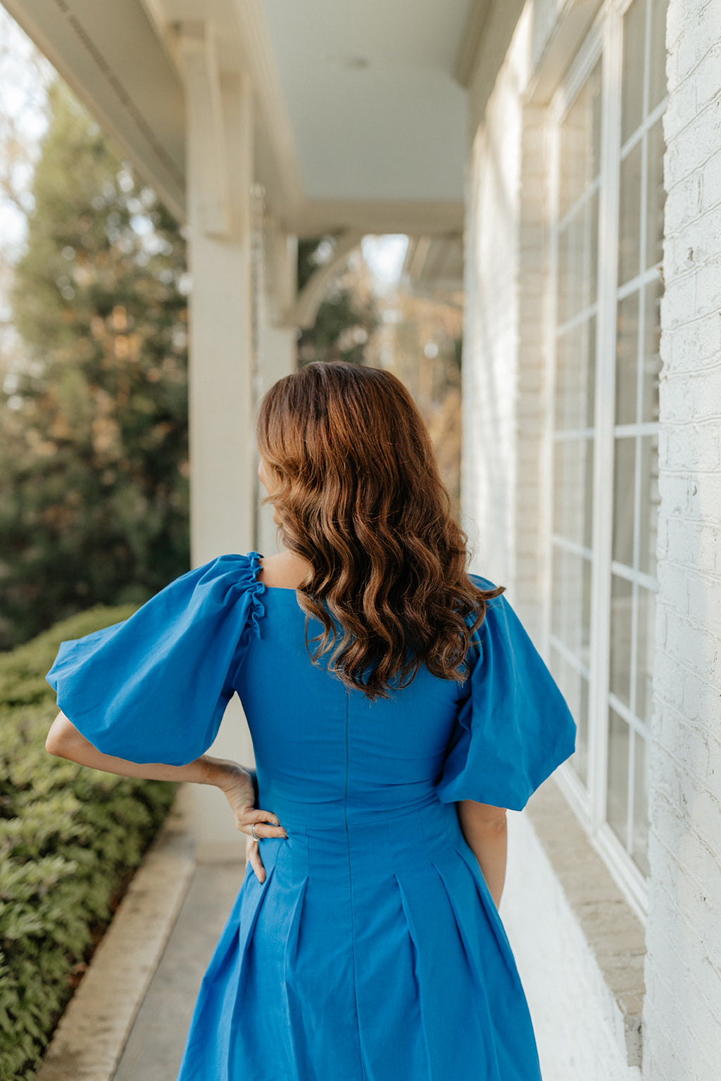 blue dress with pleats and puff sleeves