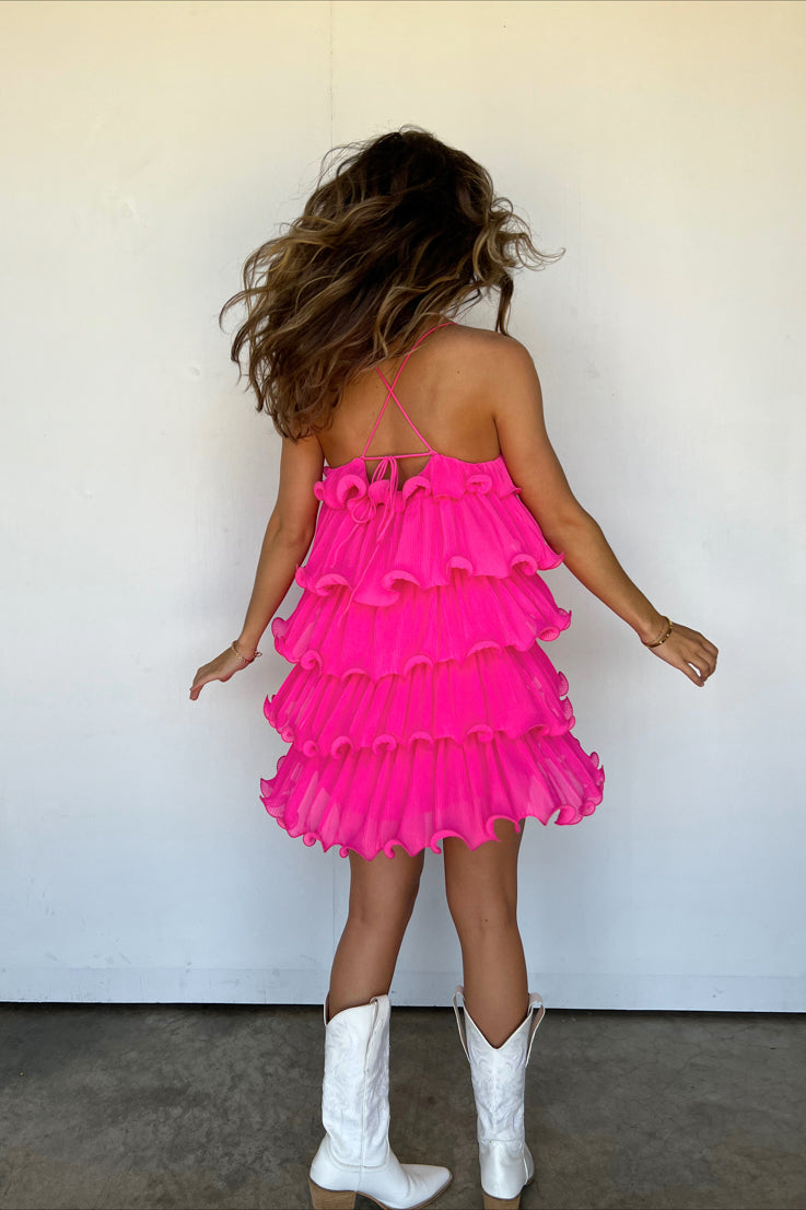 pink dress with structured ruffle tiers and thin spaghetti straps