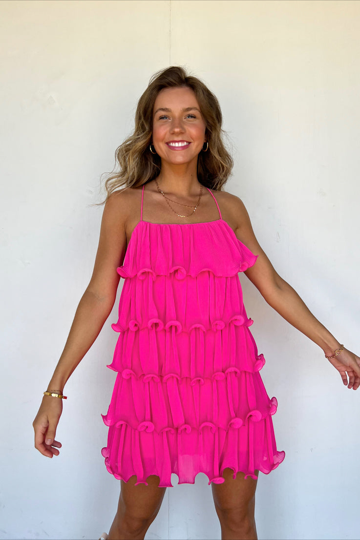 pink dress with structured ruffle tiers and thin spaghetti straps