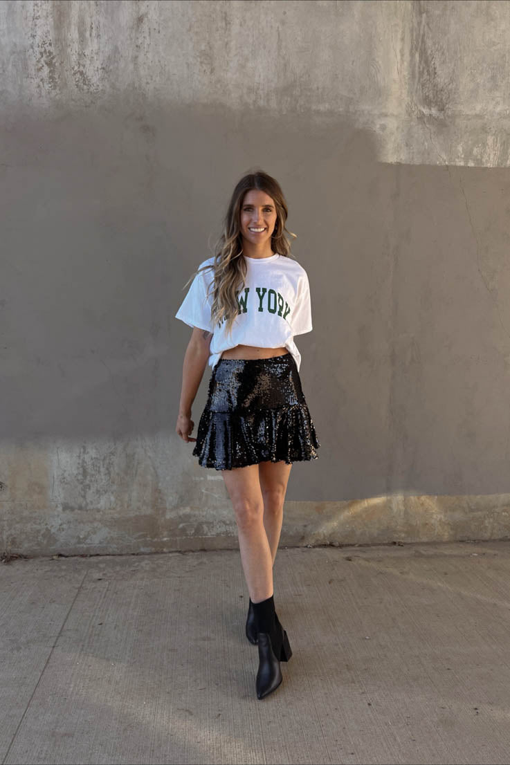white cropped tee with new york printed on the front in green